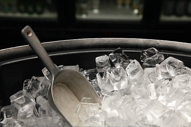 A photograph of a bucket of ice with a trowel stock photo
