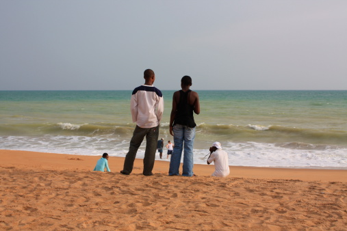 Lom!AA>, Togo - November 8, 2008: Photographer, Motiv, Model + Watching. Two students watch a photo shooting at the beach of Lom!AA> in Togo.