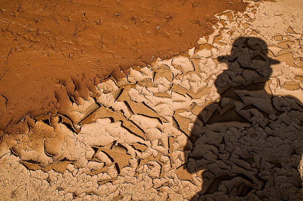 Photographer shadow on the dry mud , Thailand stock photo