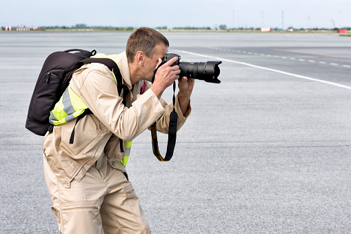 Abakan, Russia - August 08, 2020: a photographer taking pictures at the airport.