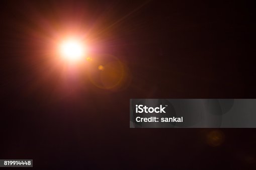 istock Photorealistic lens flare isolated on black background 819914448