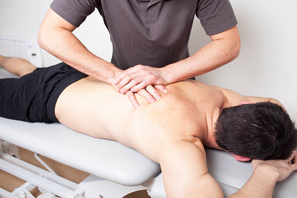 physical therapist applying myofascial therapy stock photo