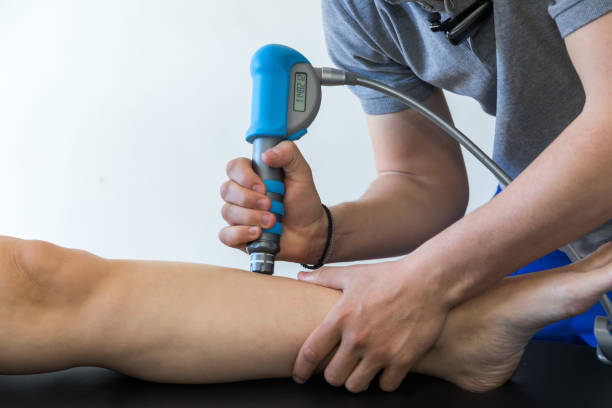 physical therapy of the knee and the foot with shock wave stock photo