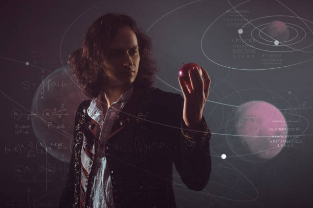 Physics the science of nature, the concept of studying the laws of nature. A young man in the image of Isaac Newton. Physics the science of nature, the concept of studying the laws of nature. A young man in the image of Isaac Newton. With an Apple in hand, the concept of the laws of gravity. isaac newton picture stock pictures, royalty-free photos & images
