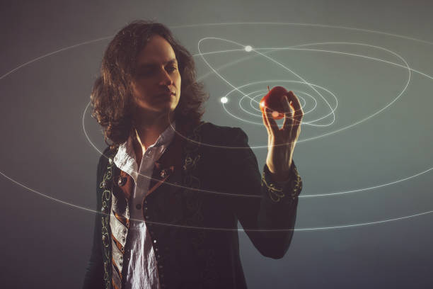 Physics the science of nature, the concept of studying the laws of nature. A young man in the image of Isaac Newton. Physics the science of nature, the concept of studying the laws of nature. A young man in the image of Isaac Newton. With an Apple in hand, the concept of the laws of gravity. isaac newton stock pictures, royalty-free photos & images