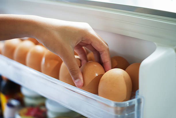 Pick eggs from the refrigerator stock photo