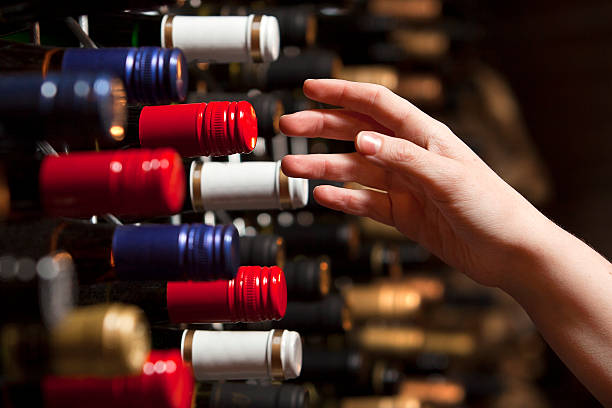 Picking a bottle of wine from the cellar stock photo