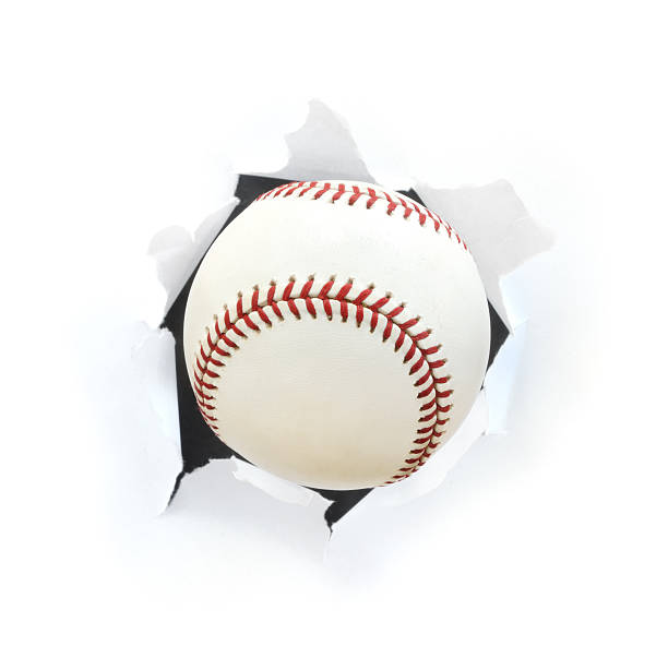 A picture of a baseball bursting through a hole stock photo