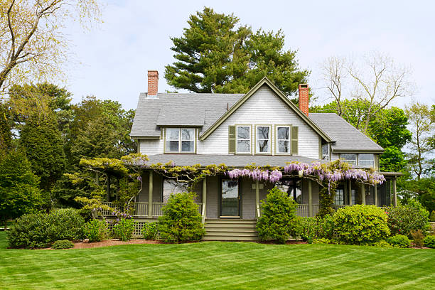 A picture of a big home with a green yard stock photo