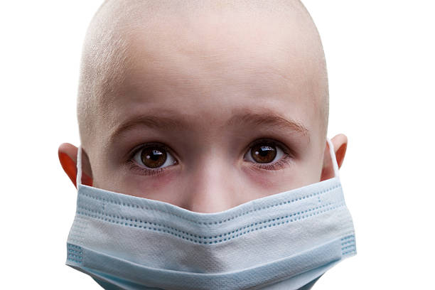A picture of a sick child in a mask stock photo