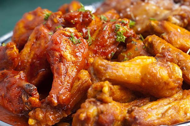 Picture of hot spicy Buffalo wings Selective-focus image of Spicy Buffalo Chicken Wings animal wing stock pictures, royalty-free photos & images