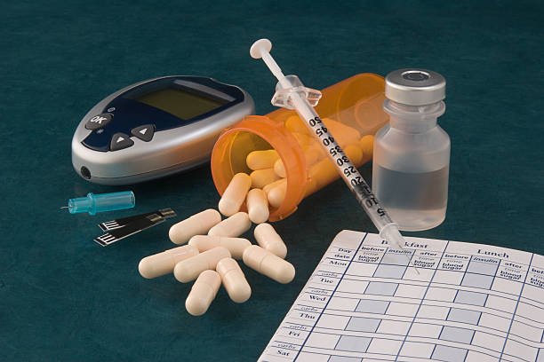 A picture of pills and diabetic supplies stock photo