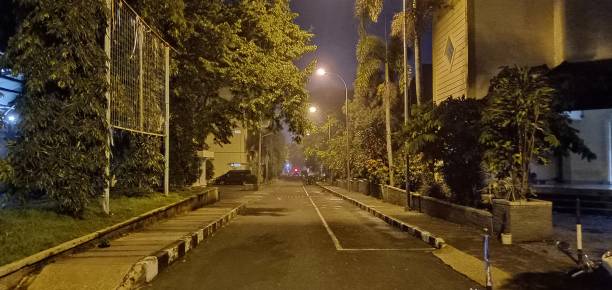 Picture Of The Road Leading Out Of The Complex At Night After The Rain stock photo