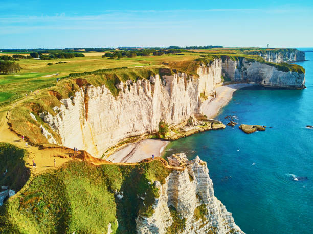 Picturesque panoramic landscape of white chalk cliffs and natural arches of Etretat, Normandy, France Picturesque panoramic landscape of white chalk cliffs and natural arches of Etretat, Seine-Maritime department of Normandy in France manche stock pictures, royalty-free photos & images