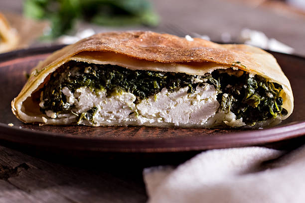 Pie or strudel with spinach and feta cheese stock photo