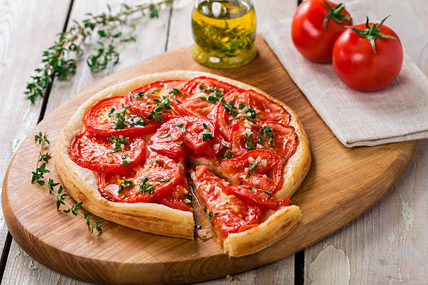 pie with tomato tart of puff pastry stock photo