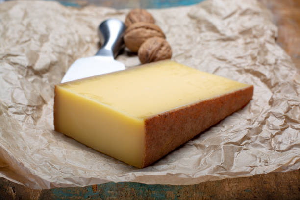 Piece of aged Comte or Gruyere de Comte, AOC French cheese made from unpasteurized cow's milk in the Franche-Comte region of eastern France with traditional methods of production. stock photo