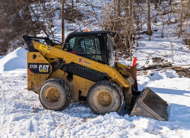 A piece of heavy machinery in a snowy field in Pittsburgh, Pennsylvania, USA stock photo