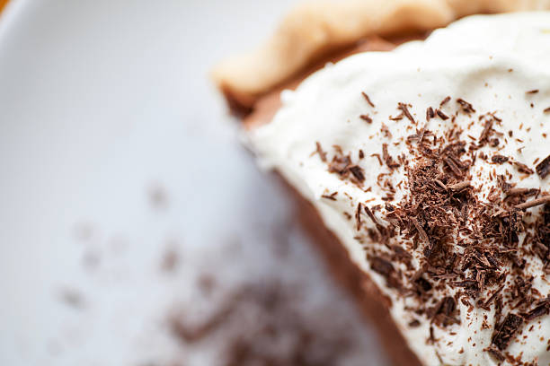 Piece of Pie A generous piece of French silk pie served fresh with homemade whip cream and shaved chocolate. semi sweet chocolate stock pictures, royalty-free photos & images
