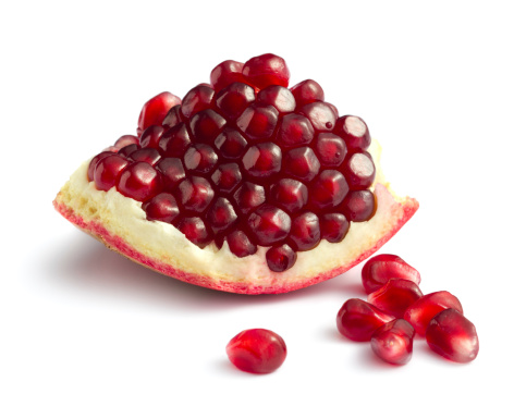 Piece of pomegranate on white backgroundOther fruits and berries: