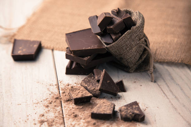 Pieces of chocolate in a bag Pieces of chocolate in a bag dark chocolate stock pictures, royalty-free photos & images