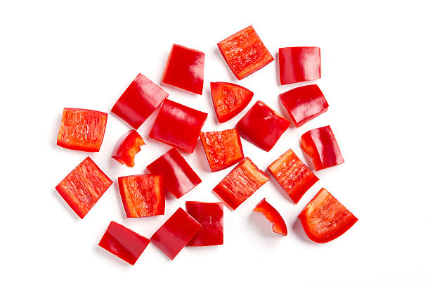 Pieces of diced red bell pepper against white background Chopped red pepper bell pepper stock pictures, royalty-free photos & images