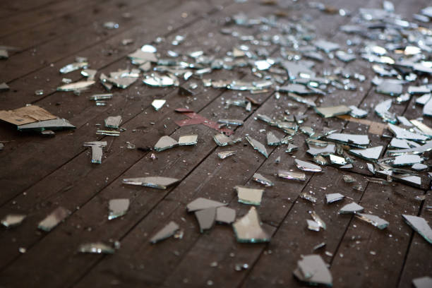 Pieces of shattered glass or mirror Pieces of shattered glass or mirror in an abandoned house vandalism stock pictures, royalty-free photos & images