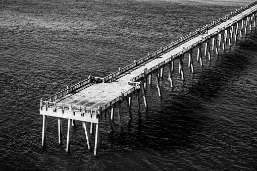 The end of the Pensacola Beach Pier in black and white shot from an altitude of about 300 feet.