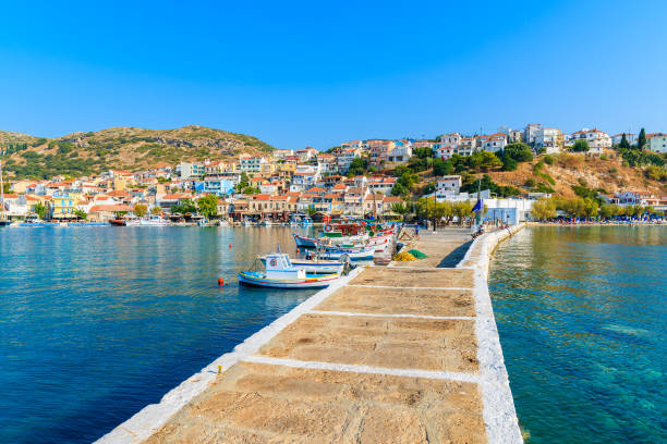 Pier in Pythagorion port with fishing boats in distance, Samos island, Greece stock photo