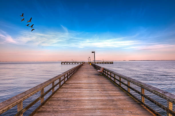 Pier into the Chesapeake Fishing pier on the Eastern shore of the Chesapeake Bay in Maryland chesapeake bay stock pictures, royalty-free photos & images
