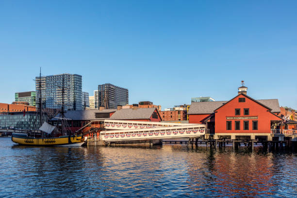 pier with historic building of the harbor site where the Boston tea party took place. in 1773 Boston: pier with historic building of the harbor site where the Boston tea party took place. The Boston Tea Party was a political protest by the Sons of Liberty on December 16, 1773. boston tea party stock pictures, royalty-free photos & images