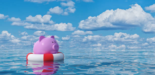 Piggy bank in lifebuoy on blue sea,Savings Protection Concept 3d render stock photo