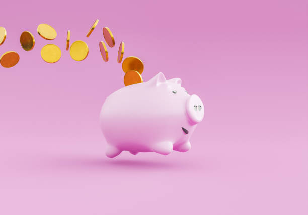 piggy bank jumping and dropping coins stock photo