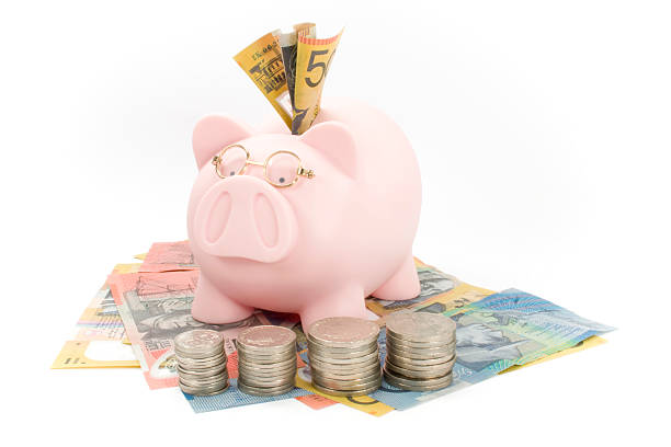 piggy bank with glasses and dollars coins stock photo