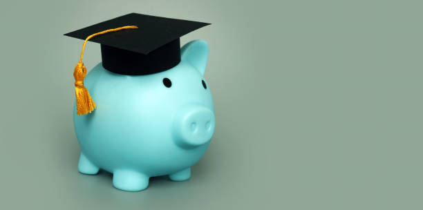 Piggy bank with graduation hat as symbol savings for education. Piggy bank with graduation hat as symbol savings for education. student debt stock pictures, royalty-free photos & images