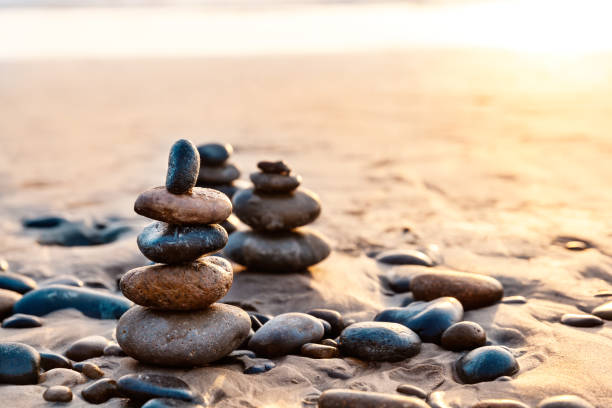 Pile Of Balanced Rocks On The Carlsbad State Beach At Sunset stock photo
