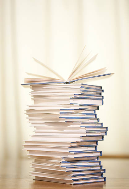 Pile of books on wood table stock photo