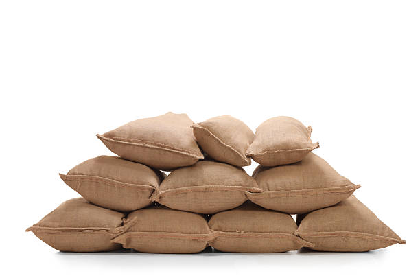 Pile of burlap sacks Pile of burlap sacks isolated on white background sack stock pictures, royalty-free photos & images