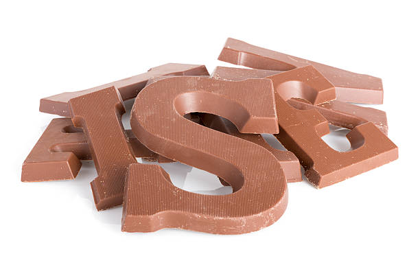 pile of choclolate letters for dutch event sinterklaas - chocoladeletter stockfoto's en -beelden