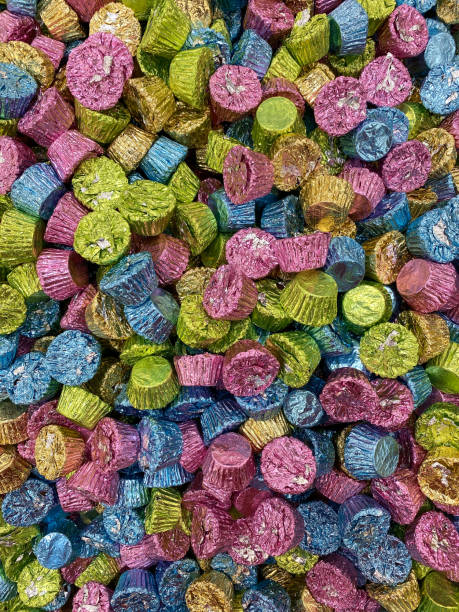 pile of chocolate peanut butter candy treats in easter pastel green blue gold pink colors stock photo