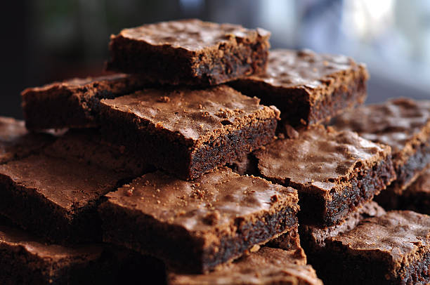 pile of delicious chocolate brownies - brownie stockfoto's en -beelden