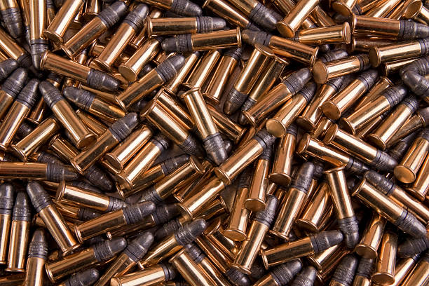 Pile of gold bulk 22 caliber ammo stock photo