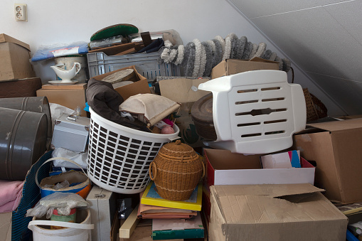 Pile of junk in a house, hoarder room pile of household equipment needs clearing out storage