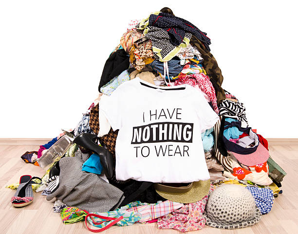 Pile of many clothes and a nothing to wear top. stock photo