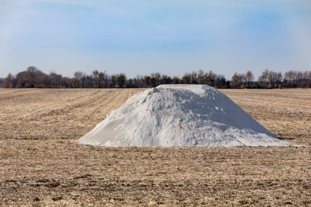Pile of pulverized agricultural lime, limestone, fertilizer in soybean field stubble waiting fall application landscape, copy space limestone stock pictures, royalty-free photos & images