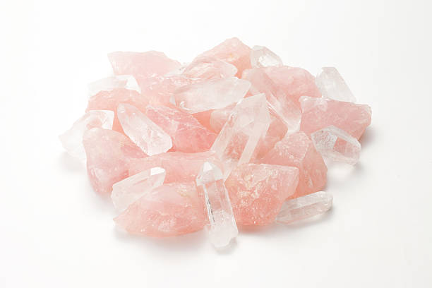 A pile of Rose quartz and crystal shards on white background Raw ore of rose quartz and Crystal rose quartz stock pictures, royalty-free photos & images
