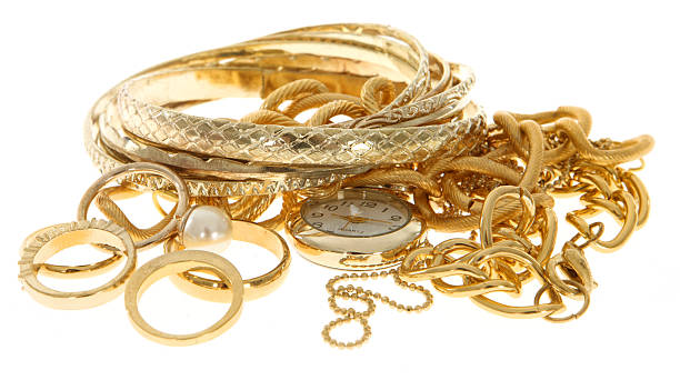 a pile of scrap gold jewelry on a white background - juwelen stockfoto's en -beelden