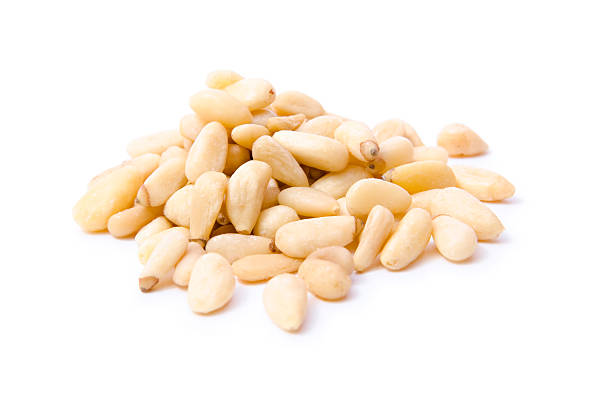 Pile of white pine nuts on a white background stock photo