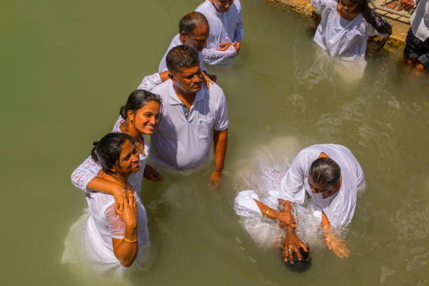 Pilgrims baptizing in the Jordan River, in the Yardenit Baptismal Site. Northern Israel. stock photo