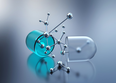 Open capsule or pill with molecular structure. Nanotechnology concept
